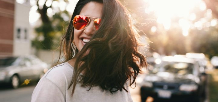 woman wearing white T-shirt smiling